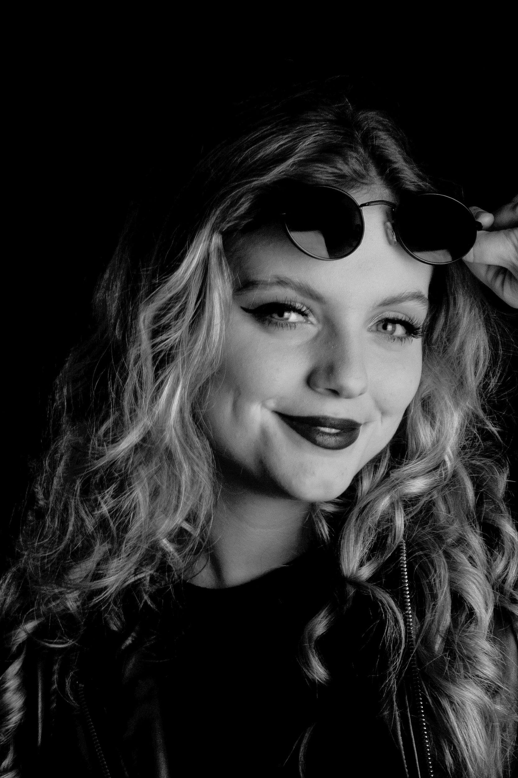 Black-and-white close-up portrait of a person wearing sunglasses