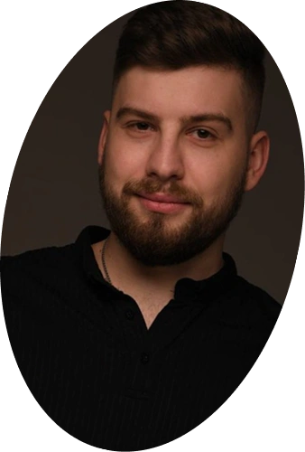 Studio portrait of a bearded person on a dark background